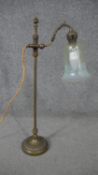 A late Victorian brass adjustable desk lamp, with an etched opalescent Vaseline glass shade, on a