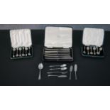 A collection of silver cutlery, including three cased sets of silver cutlery, two sets of coffee