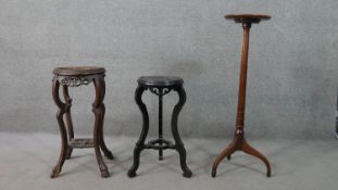 Two Chinese carved hardwood jardiniere stands, one with a grey marble top, the other ebonised,