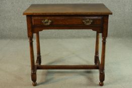 A Titchmarsh & Goodwin oak side table, 18th century style with a single drawer, oon turned legs