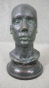 An early 20th century bronze head mounted on a turned ebonised base. H.38 W.20cm