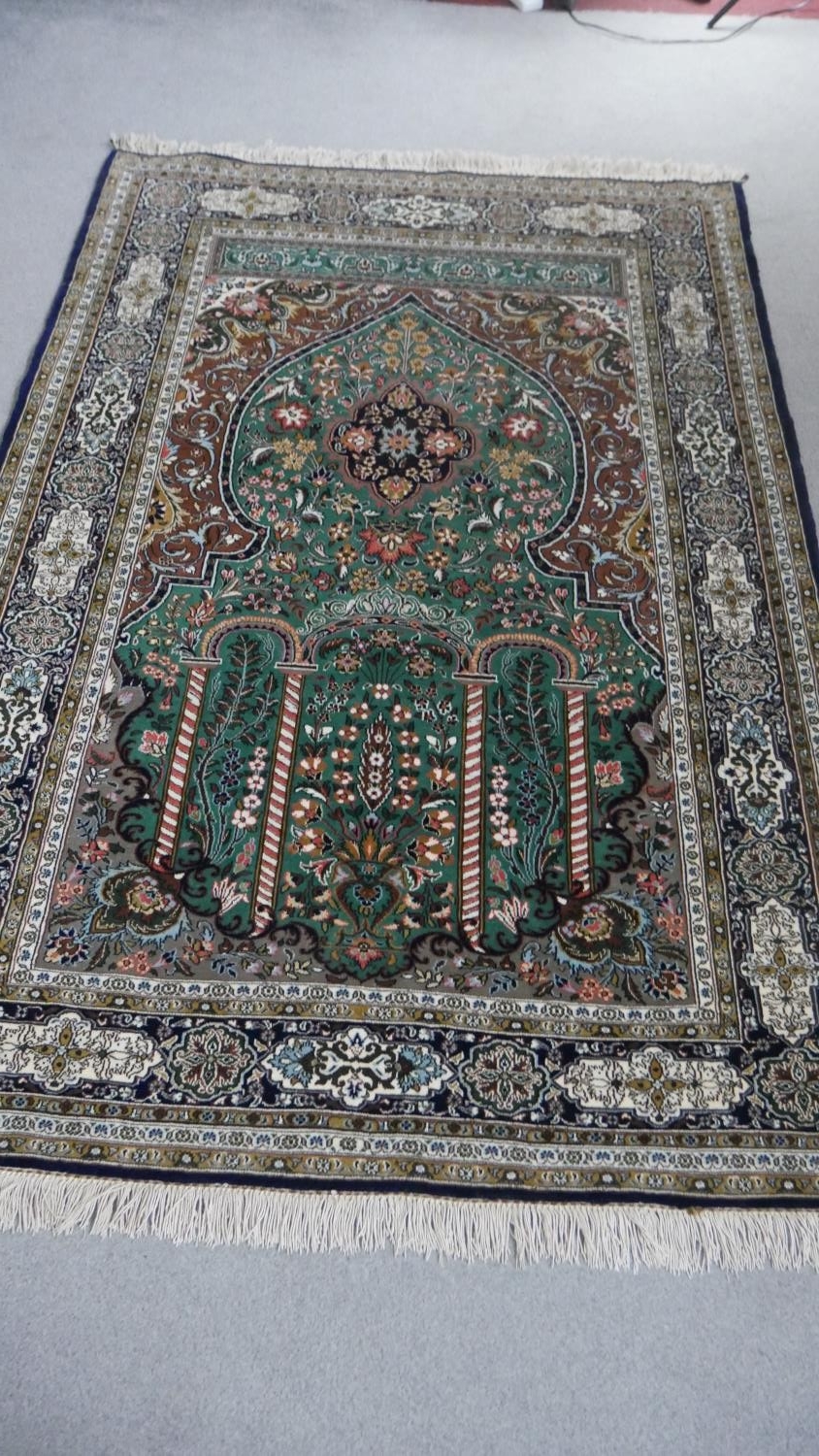 A green ground fine handmade part silk Persian Kum rug. L.207 W.136cm