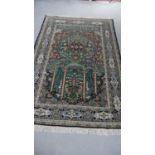 A green ground fine handmade part silk Persian Kum rug. L.207 W.136cm