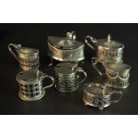 Seven 19th and 20th century sterling silver pierced design hinged lid mustard pots, various designs,