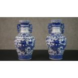 A pair of 20th century Chinese blue and white twin handled dragon design porcelain vases, Qianlong