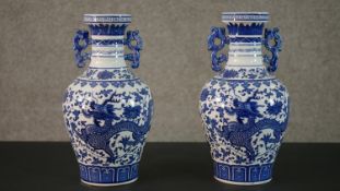 A pair of 20th century Chinese blue and white twin handled dragon design porcelain vases, Qianlong