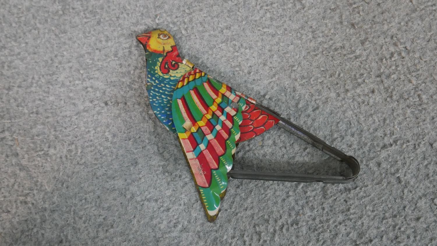 A tin plate bird with mechanism to flap the wings and make a chirp along with an early 20th - Image 2 of 7