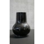 A Qing dynasty Chinese Shiwan style flambe black glaze vase. Unglazed foot. H.26 W.20cm