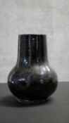 A Qing dynasty Chinese Shiwan style flambe black glaze vase. Unglazed foot. H.26 W.20cm