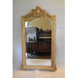 A 19th century overmantel or pier mirror in a gold painted foliate gesso frame. H.153 W.92cm