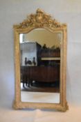 A 19th century overmantel or pier mirror in a gold painted foliate gesso frame. H.153 W.92cm