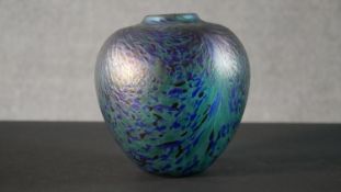 An art glass vase with oil slick finish and blue and green marbled design. H.18 W.17cm