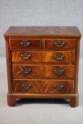 A Georgian style flame mahogany chest, with two short drawers over three long faux drawers