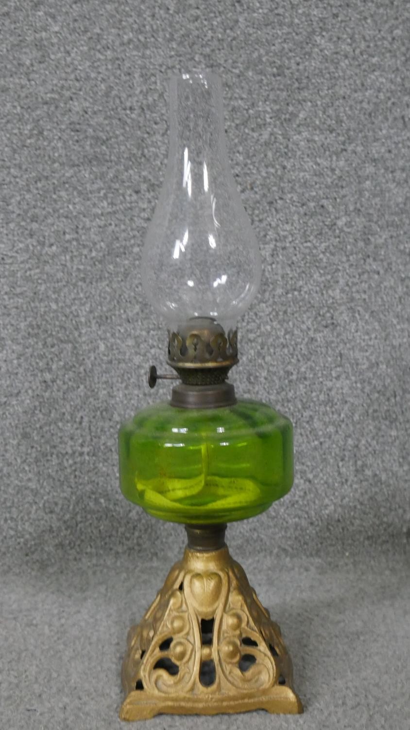 A gold painted brass Art Nouveau style oil lamp with green glass reservoir and glass funnel. H.41