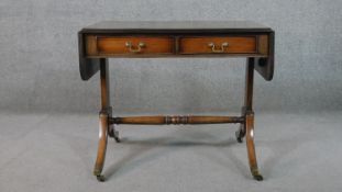 A George III style mahogany sofa table, with two drop leaves, two short drawers, on end supports