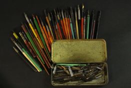 A large collection of vintage dip pens and a vintage tin of calligraphy nibs. Various makers and