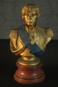 A painted gilded resin bust of Napoleon on a wood effect resin pedestal base. H.37cm