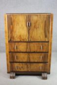 An Art Deco figured walnut tallboy cabinet, with two cupboard doors over three long drawers. H.120
