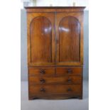 A Victorian mahogany linen press, converted to a wardrobe, with two flame mahogany doors, over two