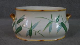 An Aesthetic movement foot bath, in the manner of Minton's, with twin faux bamboo handles, and
