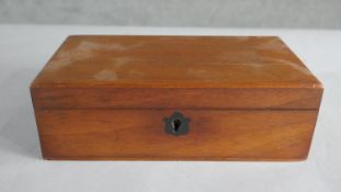 A walnut box, of rectangular form, with a shield shaped escutcheon. H.7 W.21cm