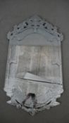 A Venetian style wall mirror, the ornate mirrored frame with bevelled edges and etched foliate