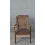 A circa 1940's beech armchair, upholstered in brown velour, open armed, with shaped supports.