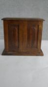 A late Victorian fruitwood tabletop cabinet, with a pair of cupboard doors, enclosing fitted