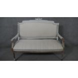 A French Louis XVI style canape sofa, the frame partially painted in light grey, the gadrooned