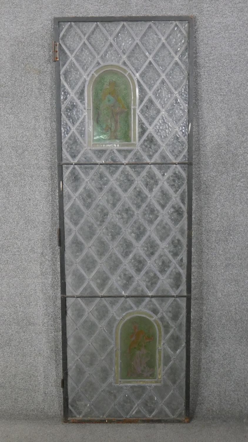 A large early 20th century lead and stained glass door with two painted coloured glass panels with