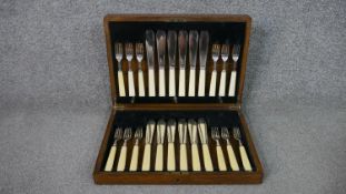 An oak canteen with a six person A1 silver plated set of fish knives and forks, makers mark FC&Co.