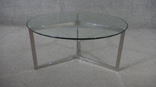 A 1970's style chrome coffee table, the circular plate glass top on a tri-form base. H.40 Diam.86cm