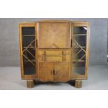 An Art Deco oak bureau sideboard, with a quarter veneered fall font enclosing a fitted interior,