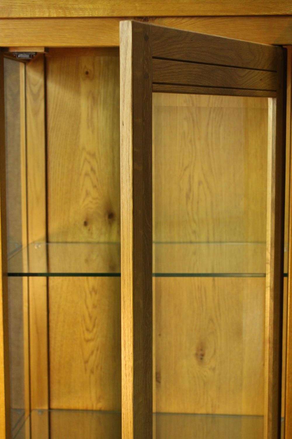 A contemporary honey oak display cabinet, with glazed door and sides, enclosing glass shelves. H.180 - Image 5 of 9