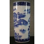 A 20th century blue and white Chinese porcelain stick stand decorated with a mountain landscape,