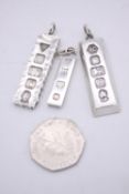 Three silver ingot pendants, each stamped to the front with a different set of hallmarks. Makers:
