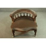 A Victorian walnut salon chair, upholstered in brown velour, the curved back supported by turned