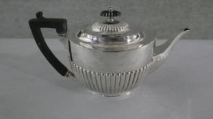 A Victorian silver gadrooned design tea pot with ebony handle and finial. Hallmarks rubbed. H.32 W.