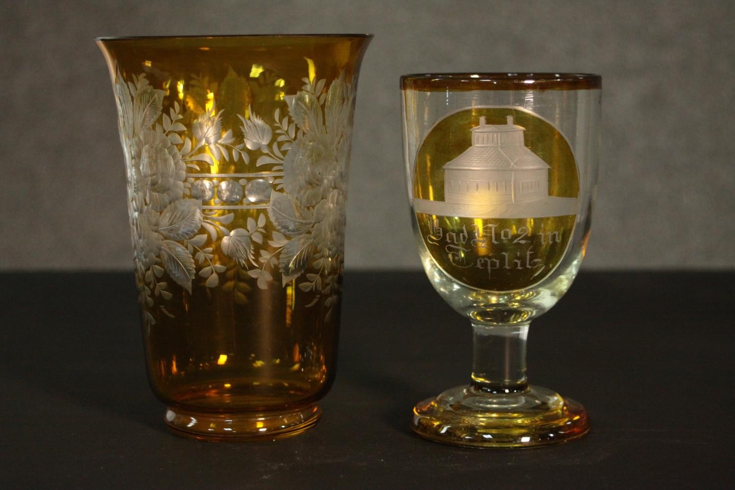 Two early 20th century Bohemian glass pieces. An amber painted clear glass etched rummer with a