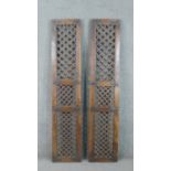 A pair of Indian teak door shutters, with a lattice design in three panels. H.185 W.38 D.4cm
