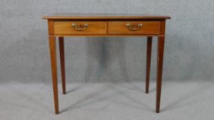 A George III style mahogany side table, the rectangular top over two short drawers, on square