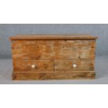 A contemporary aged pine mule chest, with a rectangular hinged top enclosing storage space over