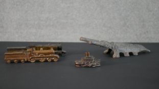 Two cast metal locomotive paperweights along with a a beetle boot scraper and a copper steam ship.