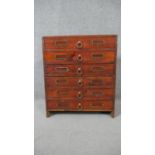 A stained pine collectors cabinet, the six long drawers with brass ring handles and fitted