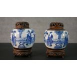A pair of 19th century blue and white crackle glaze Chinese ginger jars with figural design, pierced