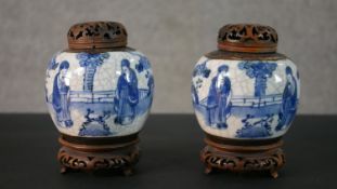 A pair of 19th century blue and white crackle glaze Chinese ginger jars with figural design, pierced