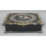 A 19th century papier-mâché writing slope with inlaid abalone shell in a floral design.