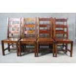 A set of eight mango wood ladder back dining chairs, the legs joined by H stretchers.