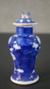 An Chinese blue and white hand painted prunus blossom design ceramic lidded vase. H.13.5 Diam.6cm
