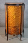 A Louis XV style French marquetry inlaid walnut drinks cabinet, the serpentine door enclosing a